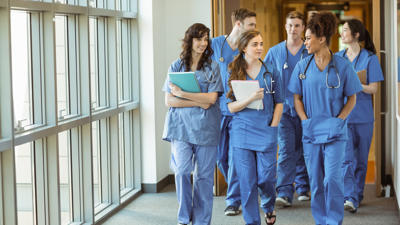 Young Doctors Walking Through Corridor
