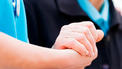 Doctor And Patient Holding Hands