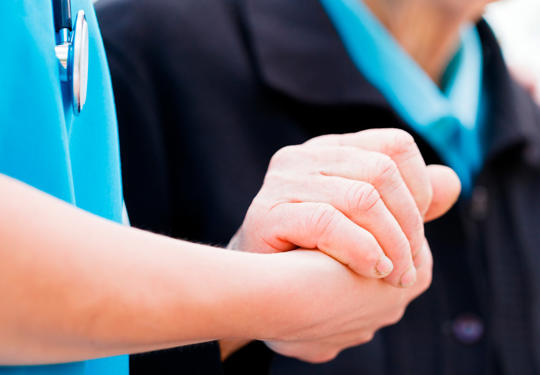 Doctor And Patient Holding Hands