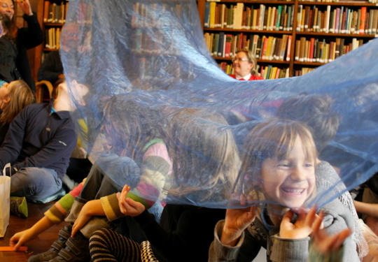 Tales From The Doctors Library - children enjoying a story in a library