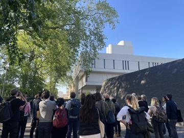 A Group Of Visitors On A Guided Tour Looking Up At The Front Of The Rcp Building